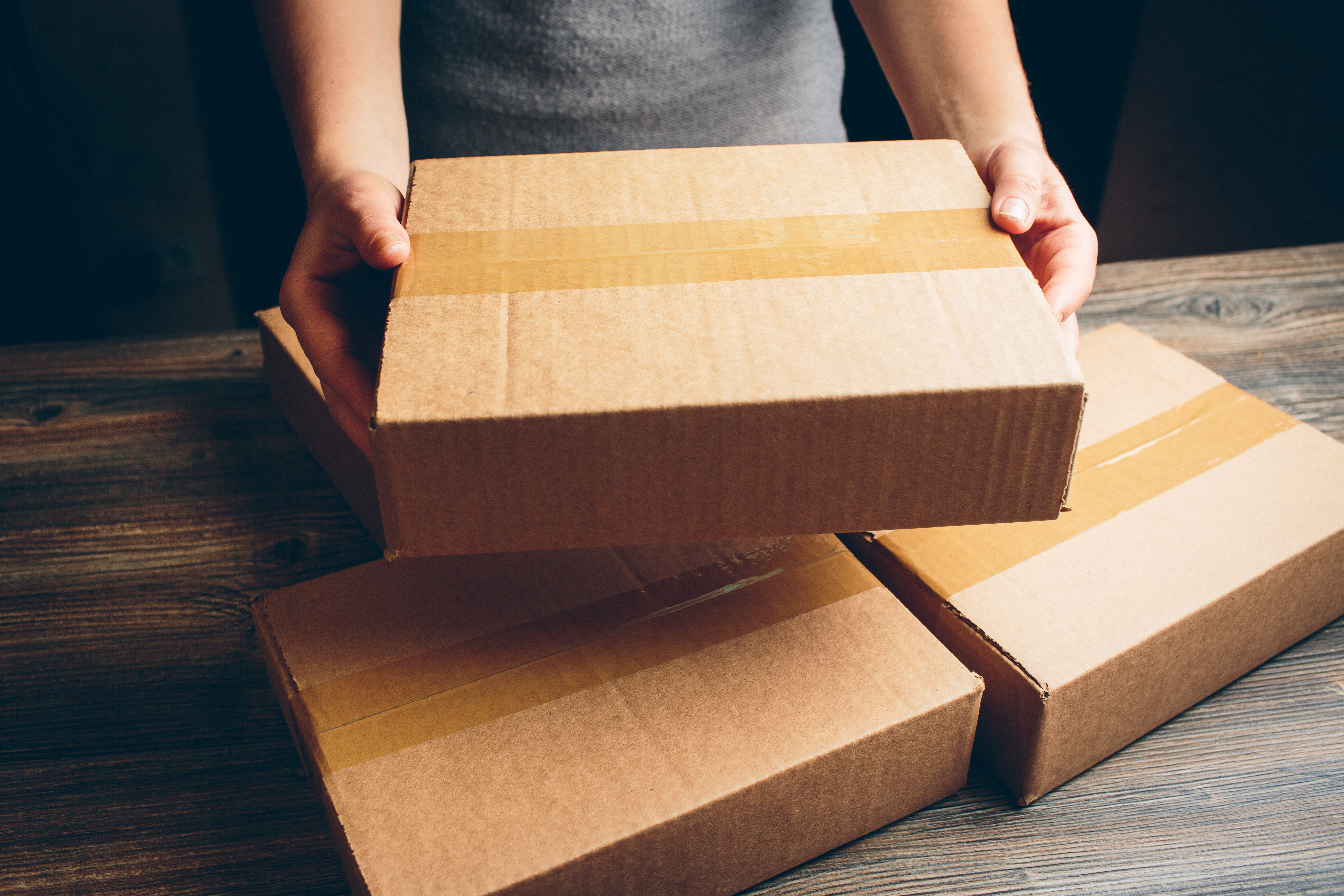 Girl's,Hands,Holding,The,Package,On,The,Table